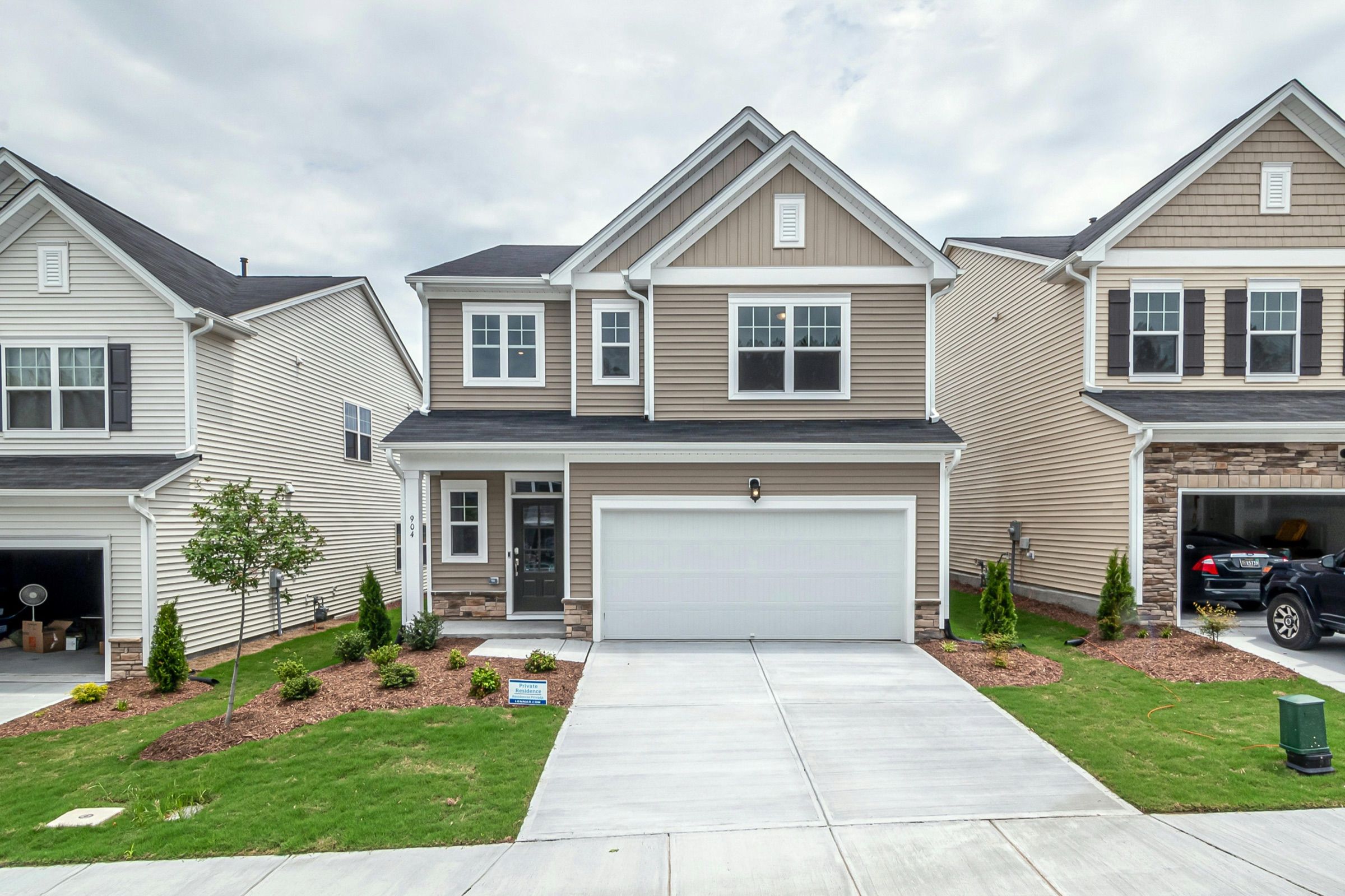 Two-storey detached house with a garage, wide driveway and front lawn